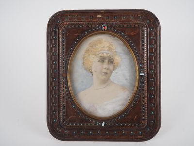 an old picture of a woman in a white dress in a wooden frame