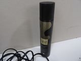 a bottle of hair spray sitting on a table next to a pair of headphones