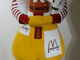 statue of a mcdonald ' s character holding a basket of food