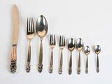 a lot of silverware on the table with a knife and fork