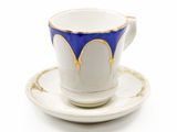 a cup and saucer on a saucer on a white surface
