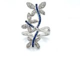 an image of a diamond and sapphire ring on a white background