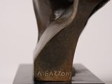 bronze bust of a man ' s head on a marble base