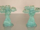 two glass vases that are sitting on a table