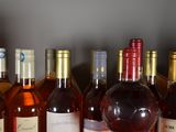several bottles of wine are lined up on a shelf