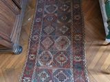 a rug on the floor in a room with a chair