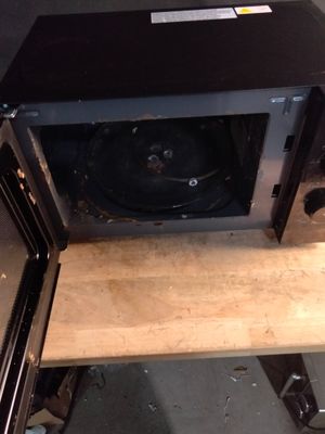 a microwave that is sitting on top of a wooden table