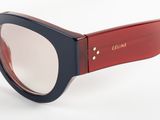 the glasses are made of plastic and have a red frame
