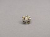a close up of a small silver bead on a white surface