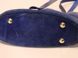 a blue purse with gold studs on it