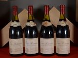 four bottles of wine are lined up in a row on a table