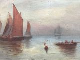 two boats that are in the water with red sails