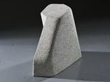 a stone sculpture that is sitting on the floor