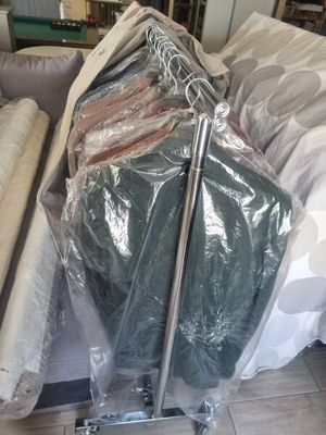 a lot of clothes on a cart in the living room