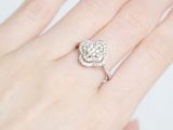 an image of a woman ' s hand with a diamond ring on it
