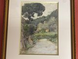 tableau représentant une rivière et un arbre, dans un cadre doré, accroché à un mur rouge