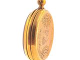 a gold colored pocket watch with a chain on a white background