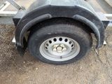 a trailer that has a tire on the side of it