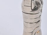 a metal object that is sitting on a white surface