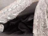 a bag of clothing wrapped in plastic sitting on a table