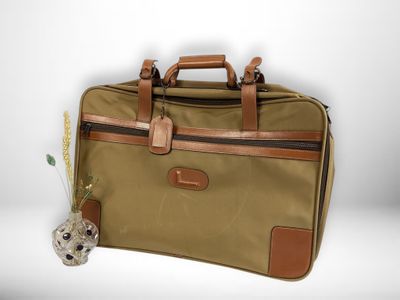 a brown bag with a brown handle sitting on a white surface