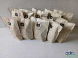 six bags of coffee sit on a table next to each other