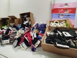 many different types of socks in boxes on a table