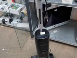 a vacuum that is sitting on the floor next to a shelf
