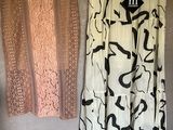 two skirts hanging on the wall next to each other