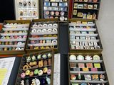 many different types of buttons in a display case