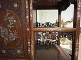 a wooden cabinet with a mirror on top of it