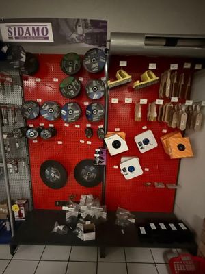 a red wall with various items on it in a store