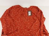a women ' s blouse with a floral pattern on it
