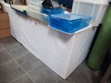 a white counter with blue bins on it in a room