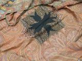 a close up picture of a scarf with a cross on it