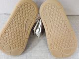 pair of children ' s shoes on a white surface with a white background