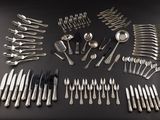 a lot of silver spoons and spoons on a table