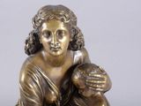 bronze statue of a woman holding a child on a marble base