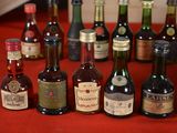 many bottles of alcohol sitting on a red table