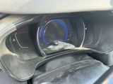 a car dashboard with a clock and a blue light