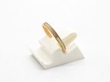 a close up of a gold ring sitting on top of a white block