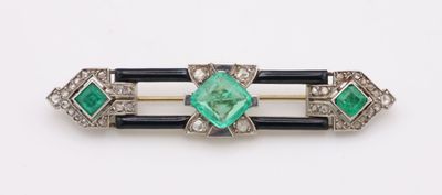 a close up of a green and white broochle on a white surface