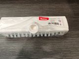 a plastic brush on a table with a barcode on it