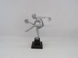 statue of a tennis player on a black base with a racket