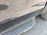 a close up of a car door with the door handle missing