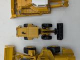 a yellow toy truck and a bulldozer next to each other