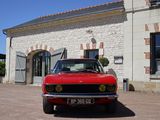a red car that is parked in front of a building
