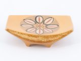 a yellow bowl with a flower design on it