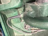 a close up of a piece of metal in a green case