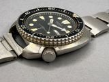 a watch that is sitting on a metal bracelet